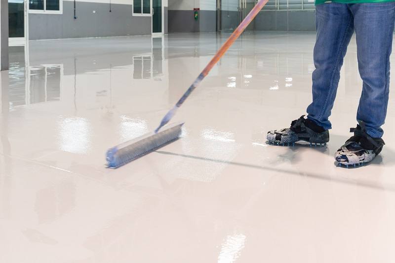 Coating being applied by hand with a squeegee by the owner-operator