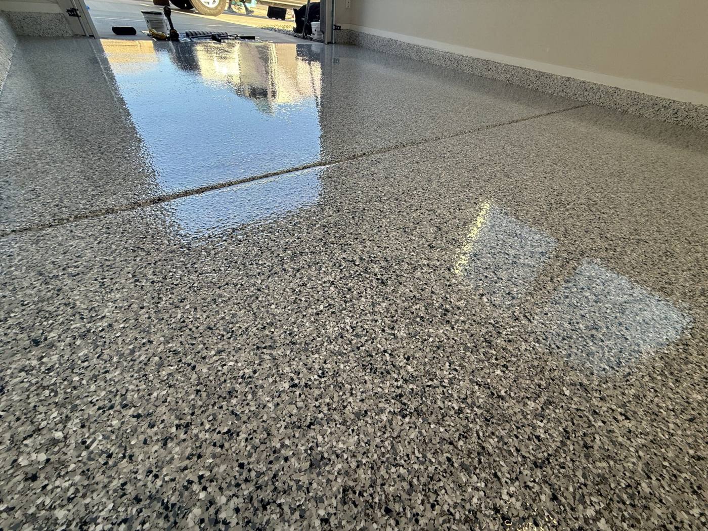 Freshly finished flake epoxy garage floor coating with a high-gloss finish
