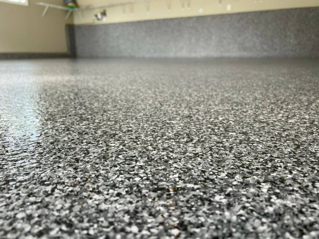 Dark epoxy coating on a commercial shop floor